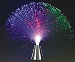 amazing accent to any room's decor. Sit back, relax and enjoy the soothing ambient light this lamp creates. It has been described as gentle raining light with the colors of the aurora. Hundreds of twinkling fiber optic strands separate in a ball of stranded light. Use our 13" fiber optic centerpiece with a cone shaped base as a decoration for your table or as a party favor. Watch the ever changing light display through its many fiber optic strands or choose from the 7 settings and choose the color you need. From Disco to Hollywood, Mardi Gras to Graduation, Birthdays to Anniversaries, Christmas to New Years, this lighted centerpiece will be a great accent to tables